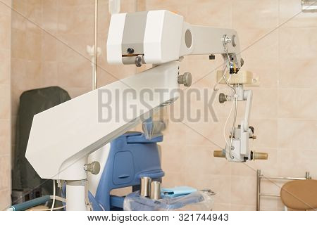 Ophthalmology Laser Microscope Operation. Clinic Room With Doctor And Parient. Gloves And Medicine T