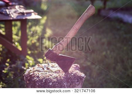 Tapor In A Wooden Bar On A Rustic Background. Chopping Wood