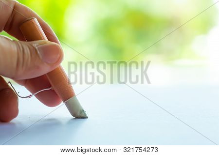 Woman's Left Hand Holding Dermatograph Pencil Writing Letter On White Paper, Bokeh Green Garden Back