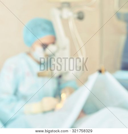 Ophthalmology Laser Microscope Operation. Clinic Room With Doctor And Parient. Blur Background. Unfo