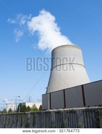 Steam And Blue Sky Above Large Chimney Of Nuclear Power Plant Near German Town Lingen In Lower Saxon