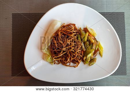 Chinese Fried Noodles. Side Dish Of Celery And Carrots. Chinese Cabbage. Brown Chinese Spaghetti Wit