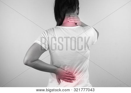 A Woman Feeling Exhausted And Suffering From Neck And Back Pain On Grey Background. Health Care And 