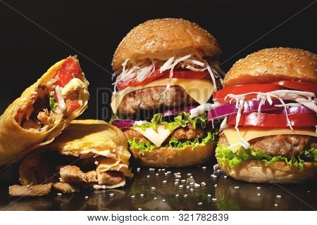 Street Fast  Food Concept On A Dark Bakground,burgers With Meat And Vegetables And Sesame Seeds, Sha