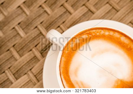 Close Up Top View Cappuccino In White Cup On Cane Wood Table At Cafe. Copyspace. Bewerages, Coffee L