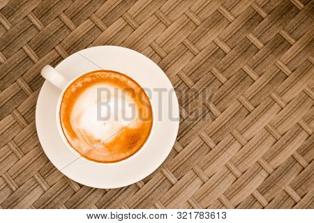 Cappuccino In White Cup On Cane Wood Table At Cafe. Top View. Copyspace. Bewerages, Coffee Lovers An