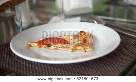 Close-up. Woman Eating Pizza While Sitting In A Restaurant With Friends