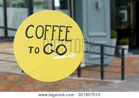Yellow Retro Outdoor Sign Coffee To Go In The Morning On The Street. 
Direction To Coffee To Go