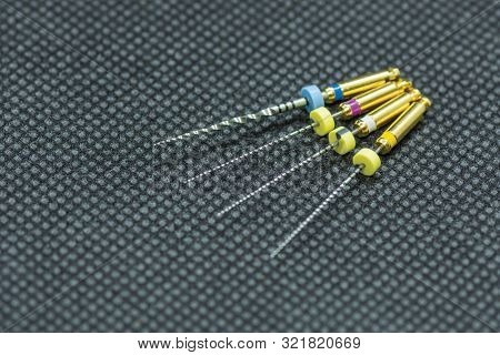 Endodontic Needles For The Treatment Of Pulpitis And Tooth Roots Close-up On Black Background. Tooth