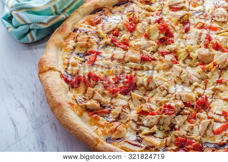 New York Style Specialty Pizza Pie With Balsamic Chicken Sundried Tomatoes And Artichoke Heart Toppi