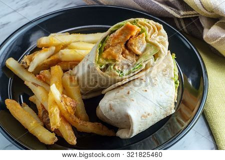 Grilled Buffalo Chicken Sandwich Wrap With Romaine Lettuce Bleu Cheese And Fries