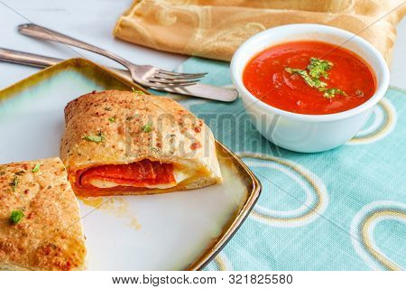 Italian Pastry Pepperoni And Cheese Calzone With Tomato Marinara Dipping Sauce