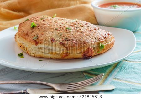 Italian Pastry Pepperoni And Cheese Calzone With Tomato Marinara Dipping Sauce