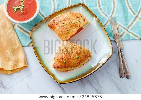 Italian Pastry Pepperoni And Cheese Calzone With Tomato Marinara Dipping Sauce