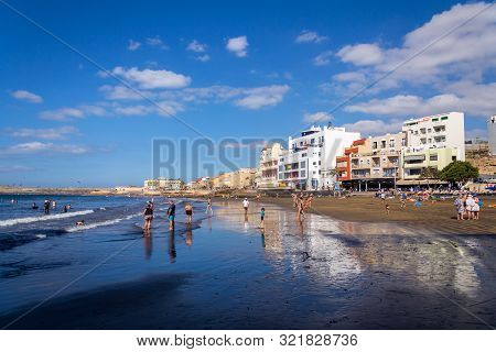 El Medano, Spain - July 7 2019: People Swimming And Sunbathing On Playa El Medano Beach On July 7, 2