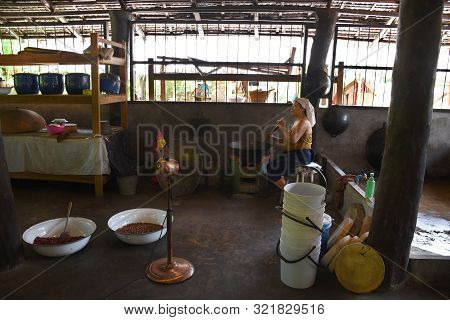 Kanchanaburi, Thailand, 09.09.2019: A Thai Lady In Traditional Thai, Siamese Dress Is Roasting Peanu