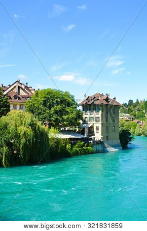 Historical Buildings Along Turquoise Aare River In The Historical Old Town Of The Swiss Capital Bern