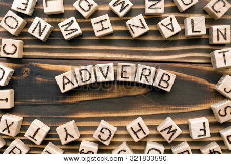 Adverb - Word From Wooden Blocks With Letters, Describes Or Gives More Information Concept, Random L