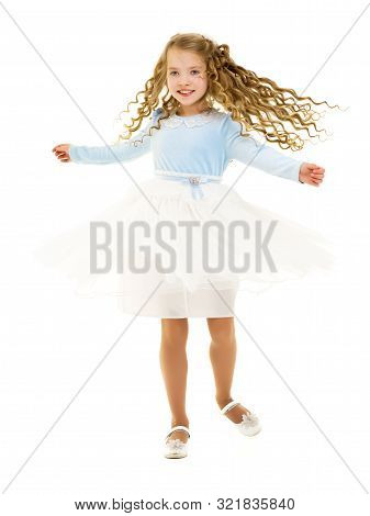 Beautiful Little Girl In A Dress Is Spinning. Concept Of Happy Childhood, Dancing, Holidays. Isolate