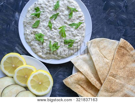 Famous Traditional Arabic Cuisine - Dip Baba Ganoush With Pita Bread And Fresh Lemon On Grey Backgro