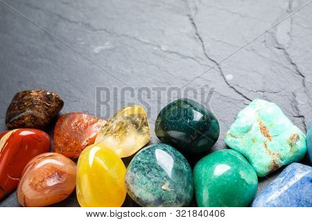 Different Gemstones On Grey Table, Closeup. Space For Text