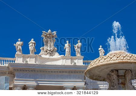 Fountain And Detail Of The Chigi Coats Of Arms And The Statues Of Saints That Crown The Colonnades O