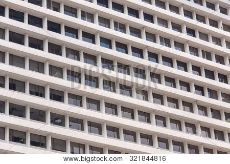 Glass windows and concrete walls in the daytime. Arcitectural fragment of modern building in Bangkok, Thailand.