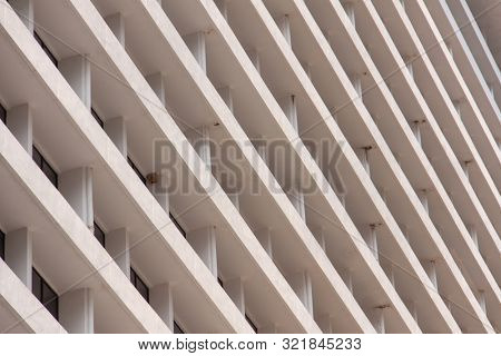Glass windows and concrete walls in the daytime. Arcitectural fragment of modern building in Bangkok, Thailand.