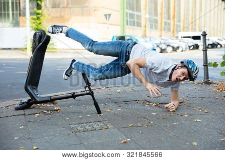 Man Having Accident Falling From E-scooter On Street