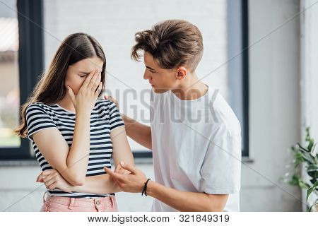 Teen Boy In White T-shirt Supporting Crying Friend