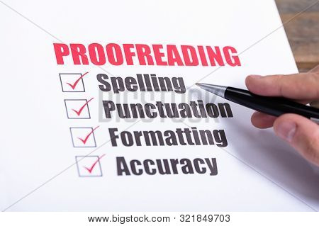 Proofreading Checklist Concept. Man Crossing Checkboxes At Desk