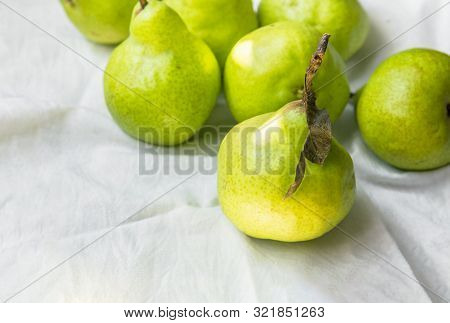 Ripe Organic Yellow Green Pears On White Cotton Table Cloth In Kitchens. Autumn Fall Harvest Local B