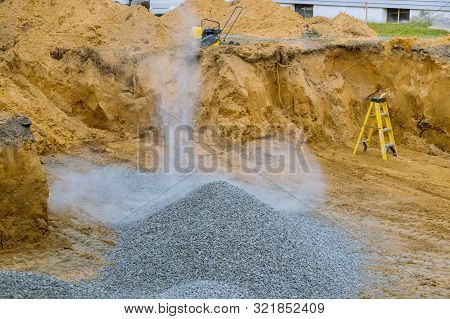 Excavator Bucket Moving Gravel Stones For Foundation Building Working On A Construction Site