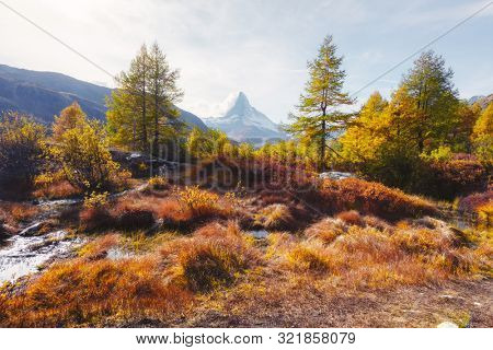 Incredible colorful sunrise on Grindjisee lake with Matterhorn Cervino peak in Swiss Alps. Zermatt resort location, Switzerland. Landscape photography