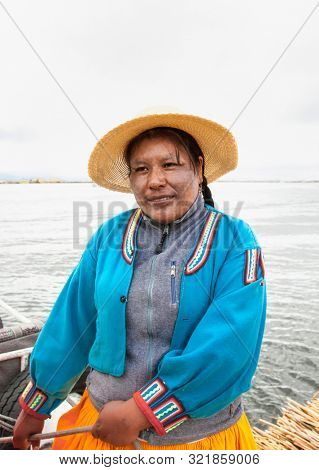 Uros, Peru- Jan 5, 2019: Portrait  of woman with hat from  Uros floating islands, Titicaca lake, Peru.