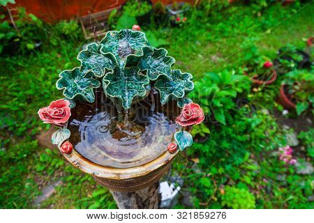A Beautiful Small Decorative Fountain Made Of Porcelain Or Clay Molded In The Form Of Green Leaves A