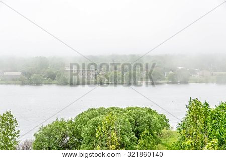 Fog Is Rolling Down The Lake On A Quiet Afternoon