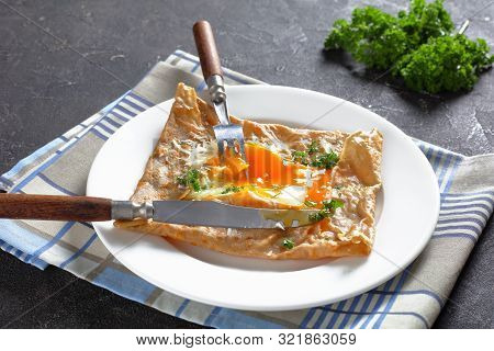 Close-up Of Breton Crepe, Savory Buckwheat Galettes Bretonnes With Spilled Egg, Cheese, Ham On A Whi