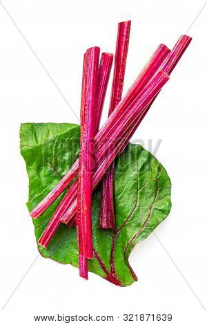 Creative Layout Made Of Fresh Rhubarb Or Rheum With Stalks, Leaves  And Pieces  Vegetable Isolated O