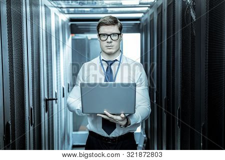 Handsome Adult Investigator With A Laptop Looking Serious