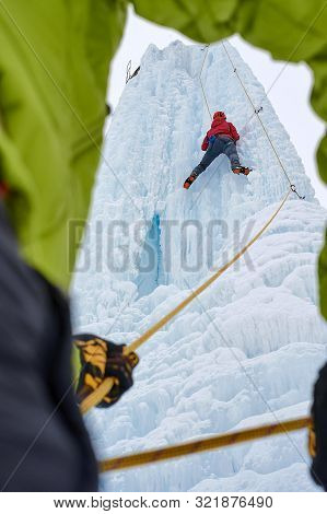 Ice Climber Belay With A Rope And Click Up. Hands Close Up