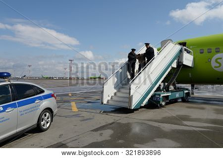 Moscow, Russia - April 26, 2018: Police Officers Take Aircraft Brawler Off The Plane