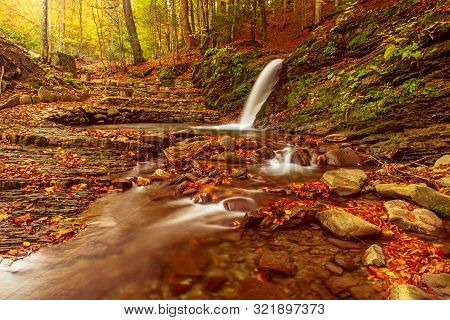 Autumn Mountain Waterfall Stream In The Rocks With Colorful Red Fallen Dry Leaves, Natural Seasonal 