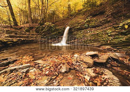 Autumn Mountain Waterfall Stream In The Rocks With Colorful Red Fallen Dry Leaves, Natural Seasonal 