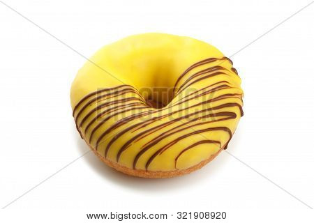 Sweet Doghnut With Yellow Glaze Decorated With Chocolate On A Paper Plate Isolated On A White Backgr