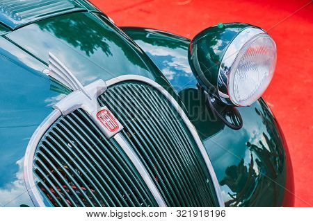 Closeup Of Old Vintage Green Fiat 500 Topolino Car On Red Background