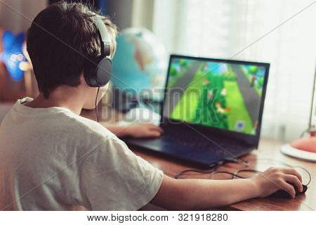 Little Dependent Gamer Boy Playing On Laptop At Home