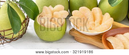 Fresh Peeled Pomelo, Pummelo, Grapefruit, Shaddock On Bright Wooden Table Background. Seasonal Fruit