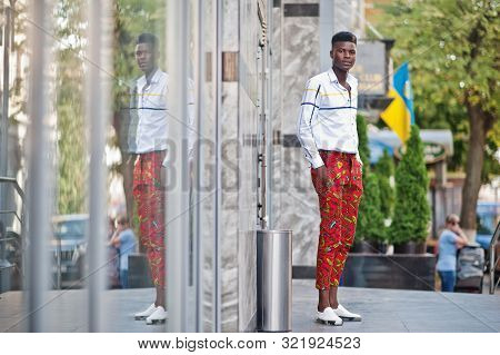 Portrait Of Handsome Stylish African American Model Man In Red Throusers And White Shirt.