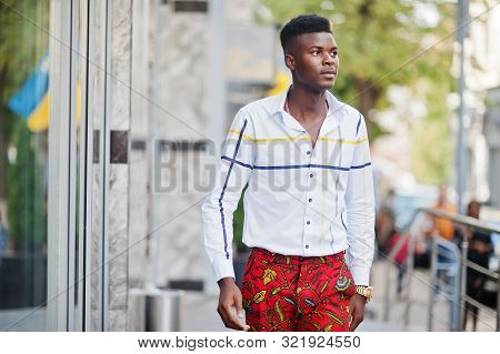 Portrait Of Handsome Stylish African American Model Man In Red Throusers And White Shirt.